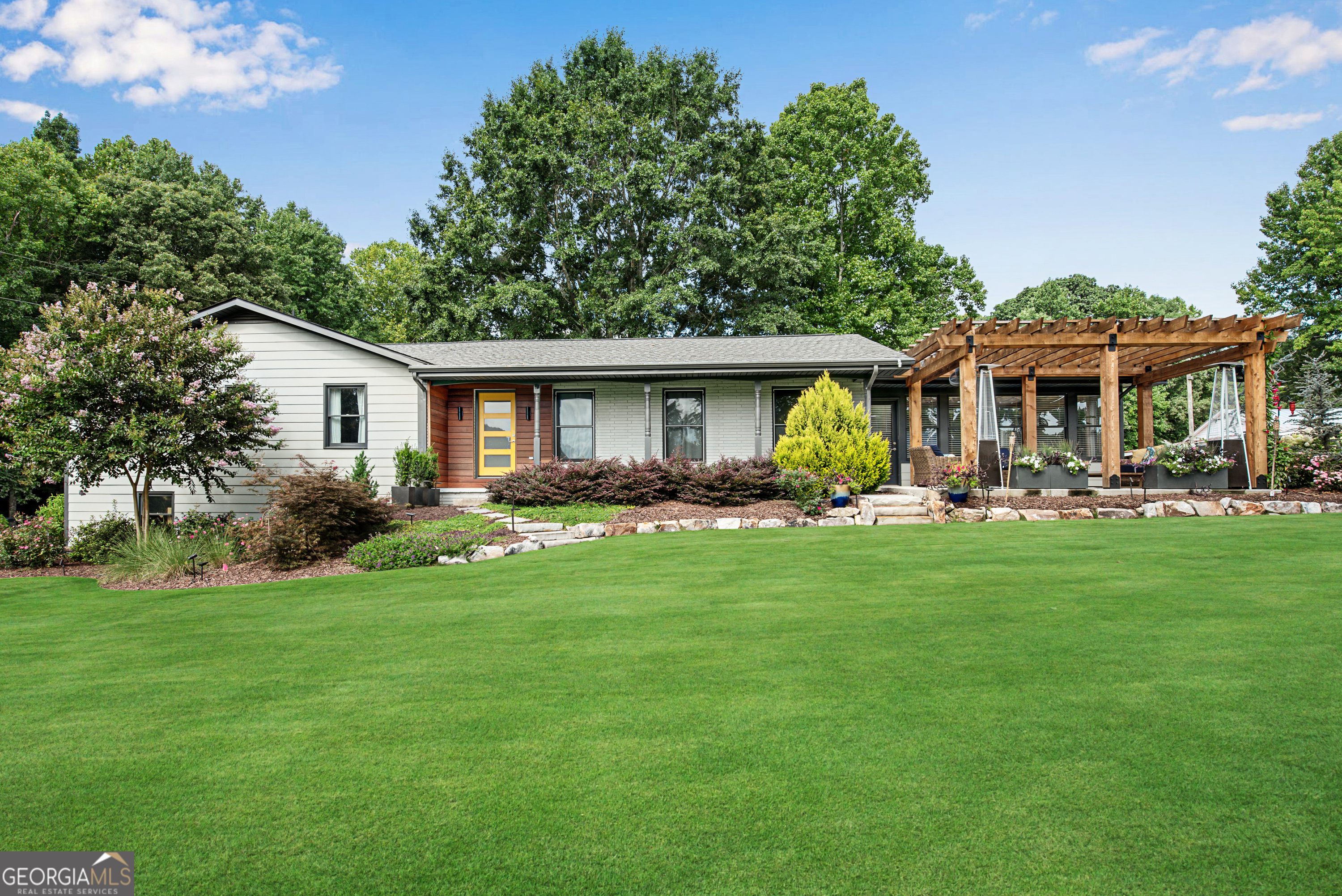 a front view of a house with a yard table and chairs