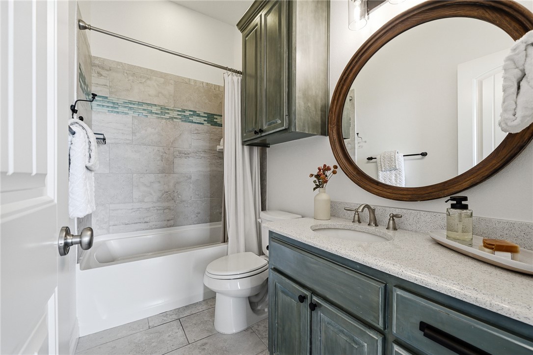 8710 KIng Ranch Drive Corpus Christi, TX 78414 - Photo 18 of 38 a bathroom with a sink a toilet and a mirror