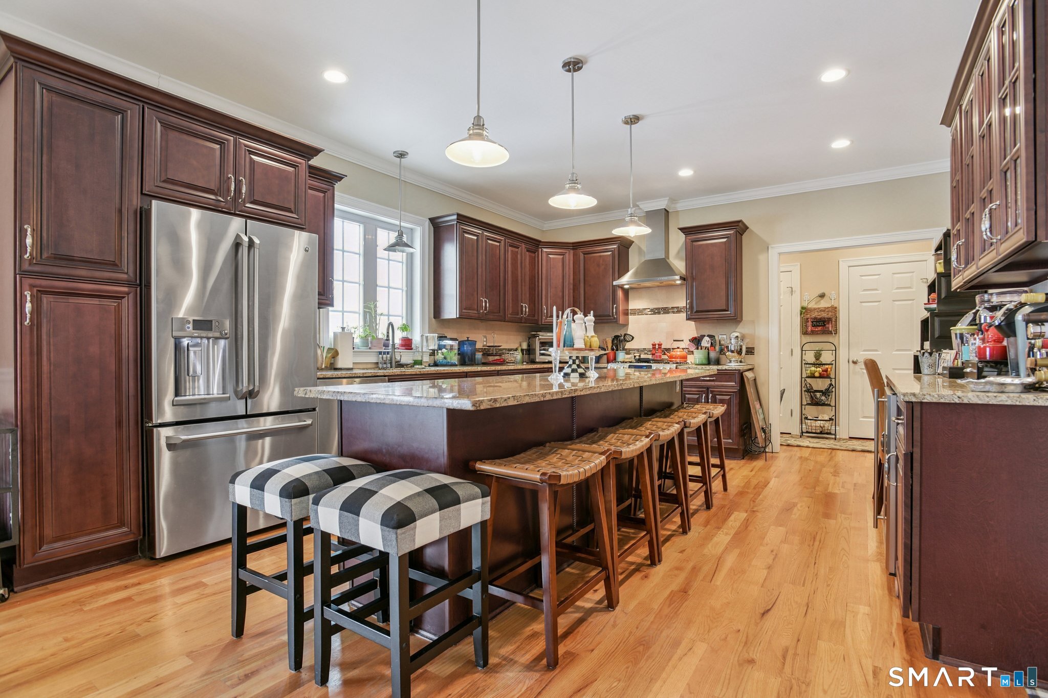 10 Ball Road North Haven, CT 06473 - Photo 11 of 35 a kitchen with stainless steel appliances granite countertop a refrigerator a stove top oven a sink dishwasher and white cabinets with wooden floor