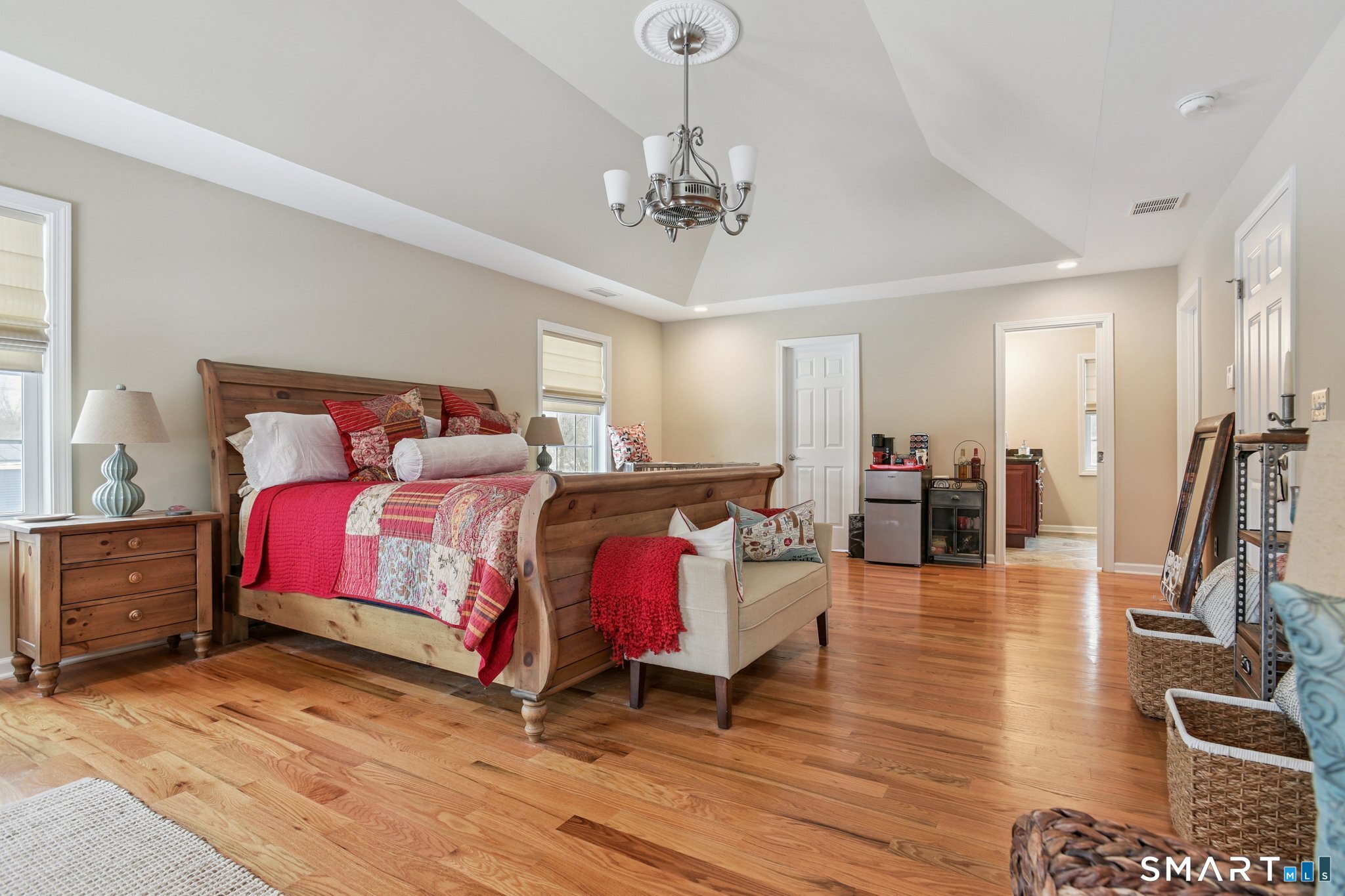 10 Ball Road North Haven, CT 06473 - Photo 19 of 35 a bed room with a bed and a chandelier