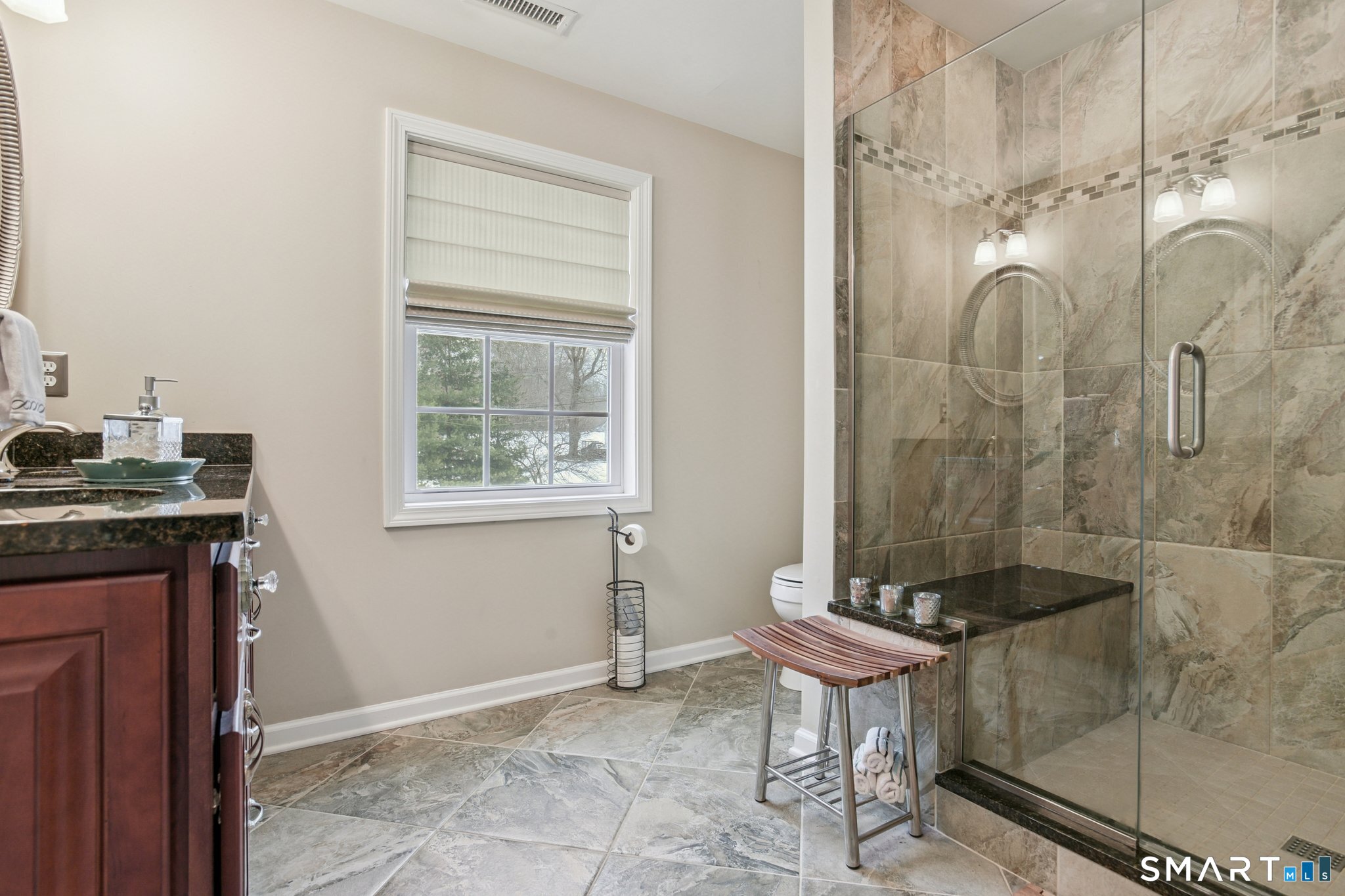 10 Ball Road North Haven, CT 06473 - Photo 20 of 35 a bathroom with a granite countertop sink a mirror and a shower