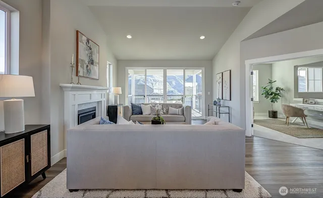 a living room with fireplace furniture and a large window