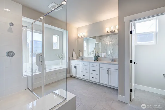 a bathroom with a double vanity sink mirror and shower