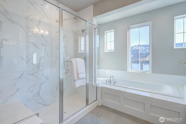a bathroom with a tub shower and sink