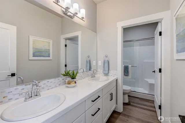 a bathroom with a double vanity sink and a mirror