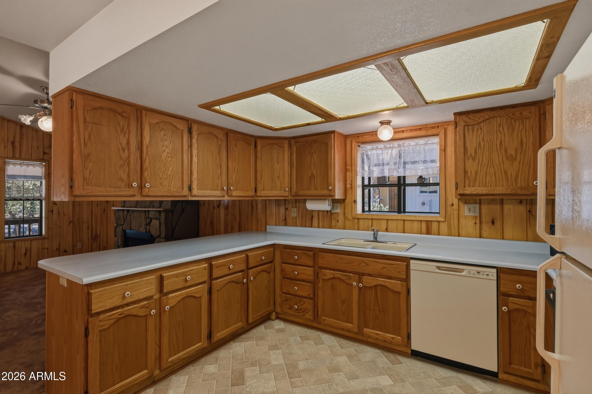 809 North Ponderosa Circle Payson, AZ 85541 - Photo 12 of 21 a kitchen with stainless steel appliances granite countertop a sink and dishwasher with wooden cabinets