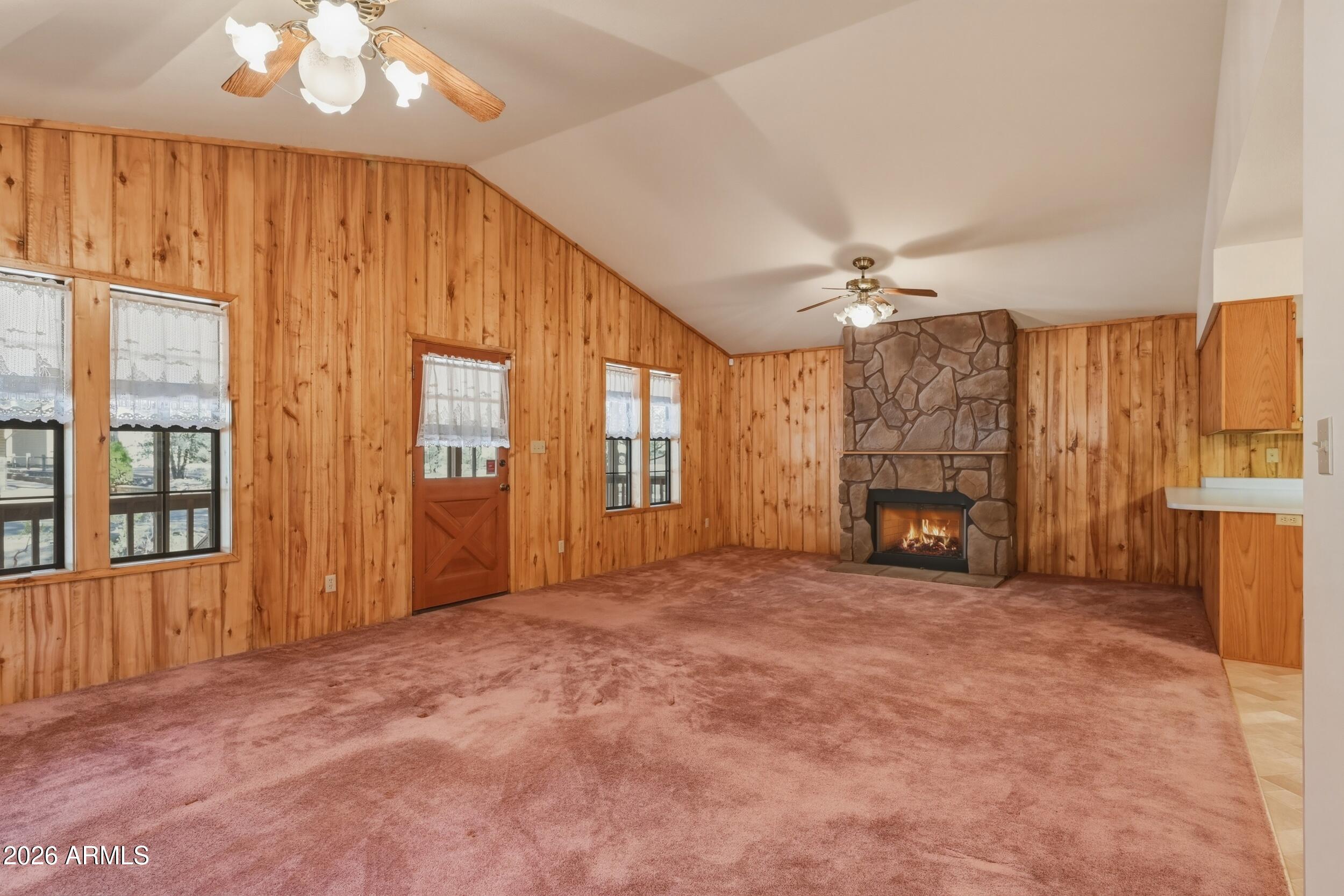 809 North Ponderosa Circle Payson, AZ 85541 - Photo 6 of 21 a view of an empty room with a fireplace and a window