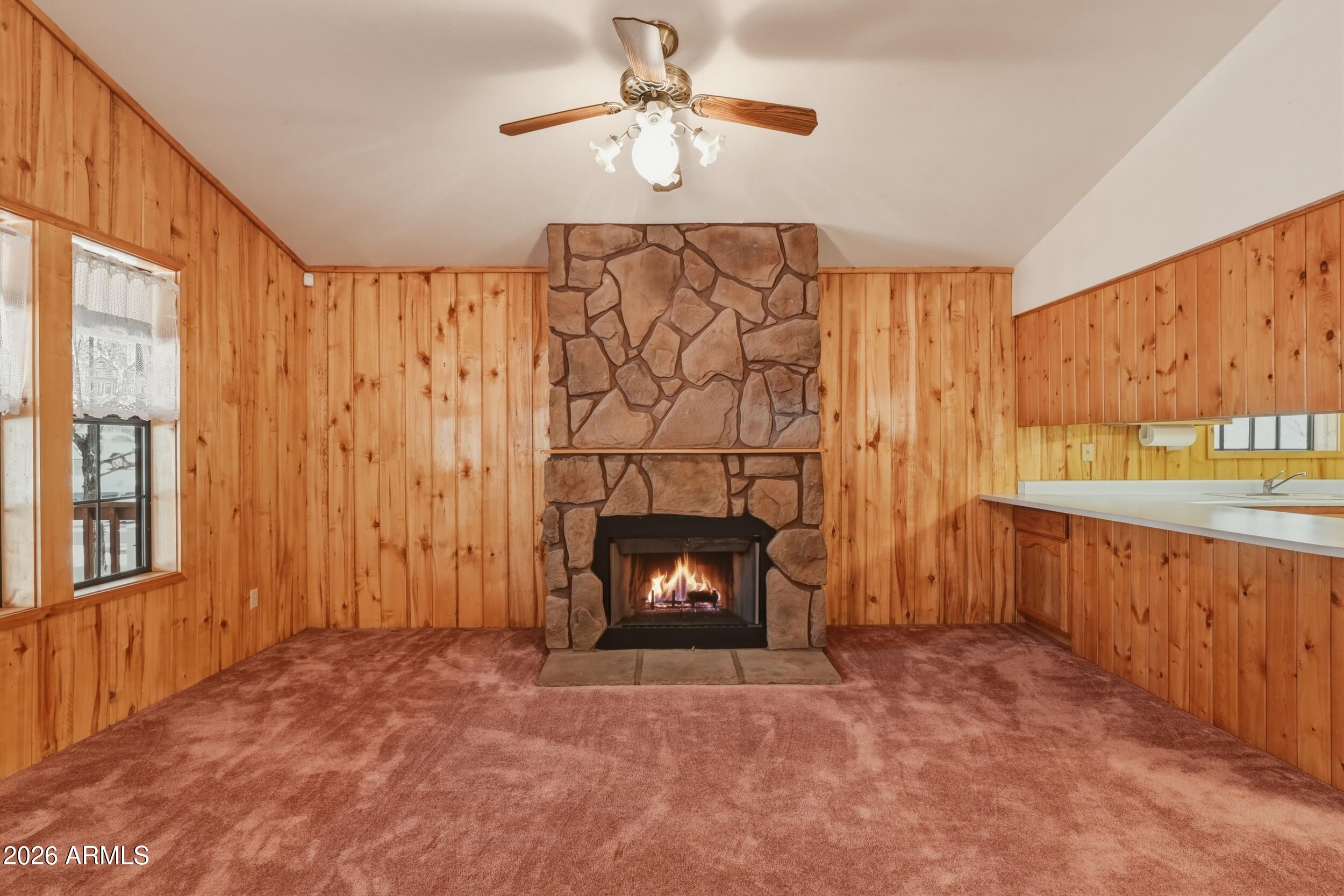 809 North Ponderosa Circle Payson, AZ 85541 - Photo 7 of 21 a view of an empty room with a fireplace and a window