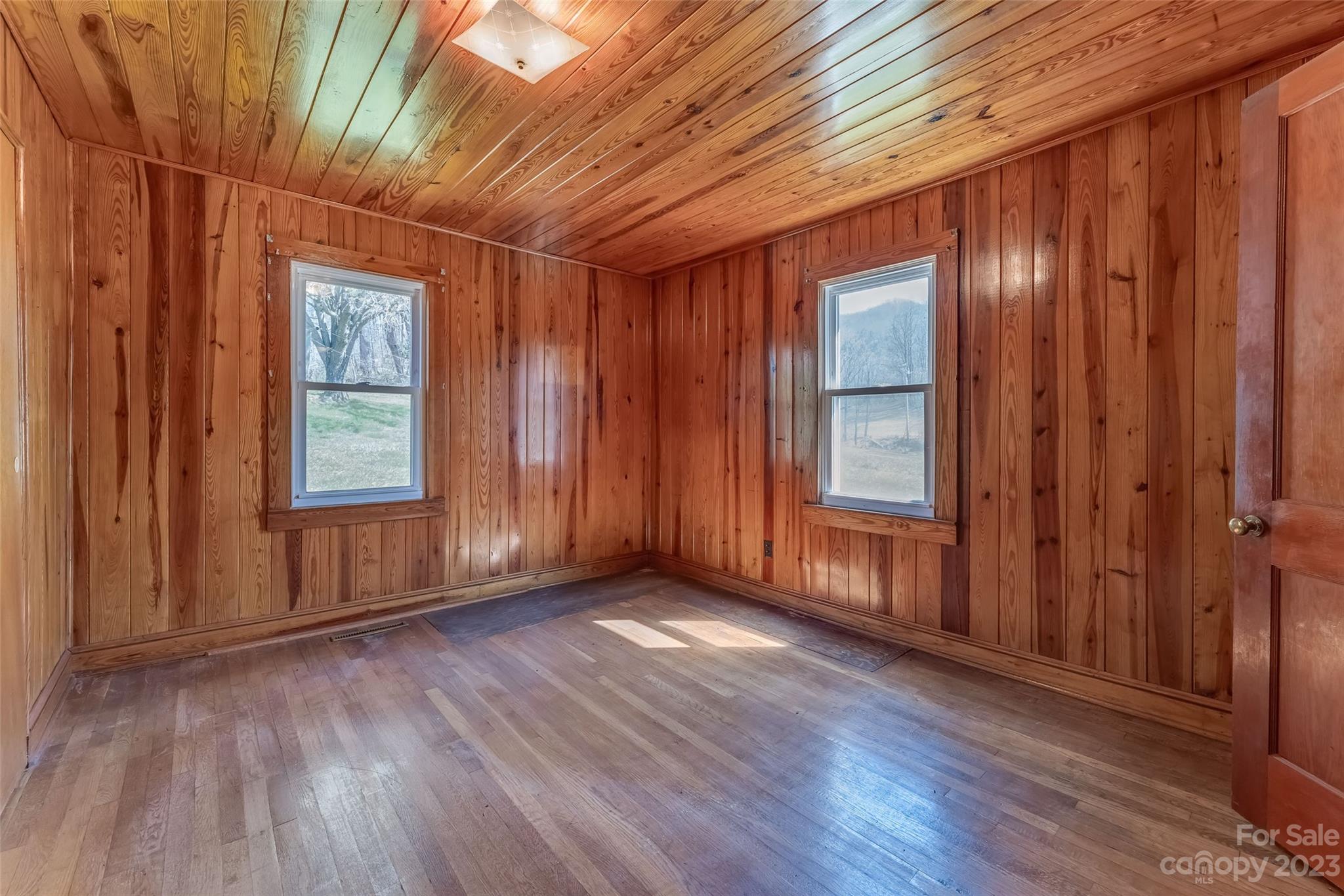 1345 Max Thompson Road Canton, NC 28716 - Photo 21 of 43 an empty room with wooden floor and windows