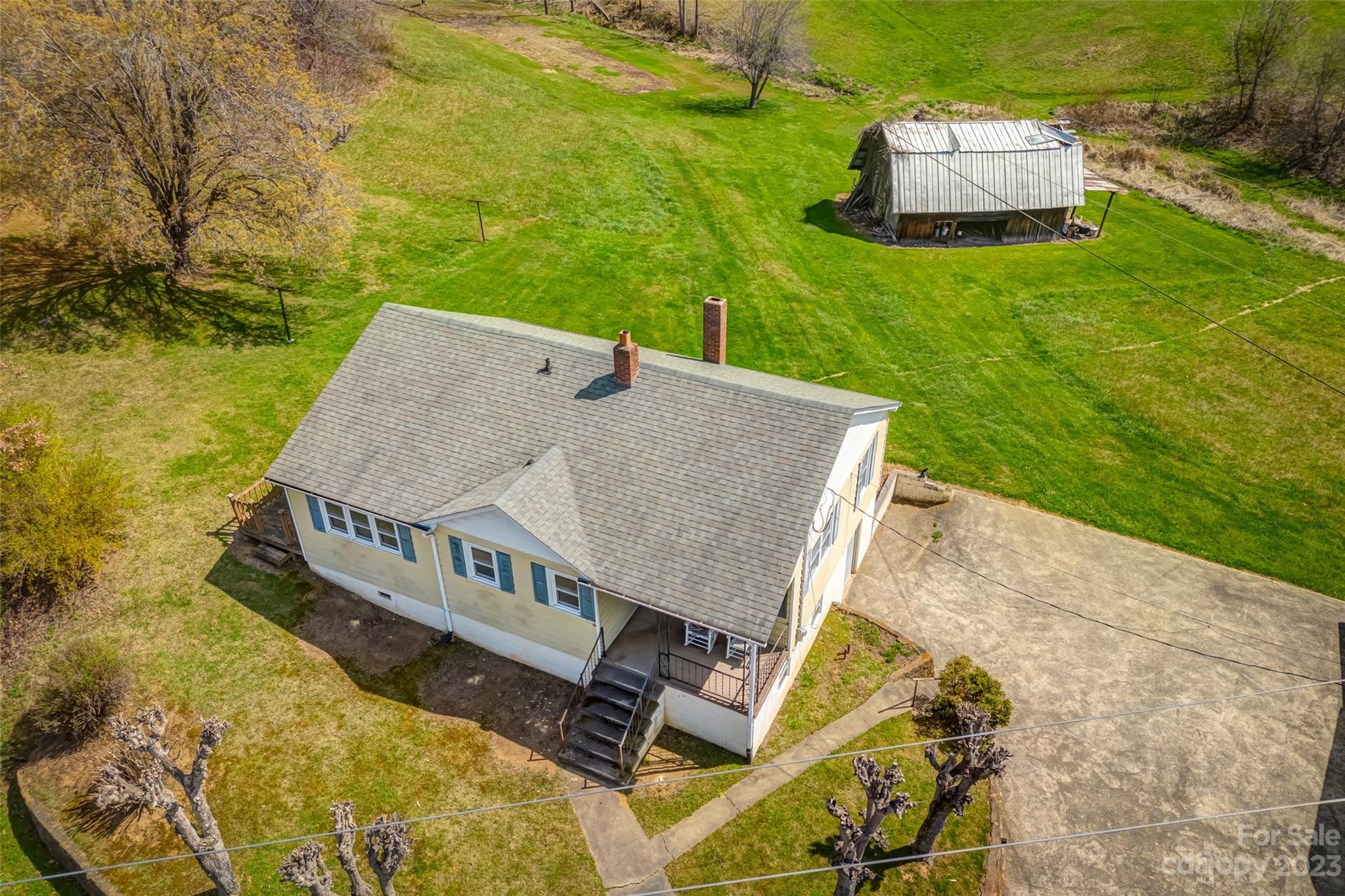 1345 Max Thompson Road Canton, NC 28716 - Photo 43 of 43 an aerial view of a house with swimming pool and large trees