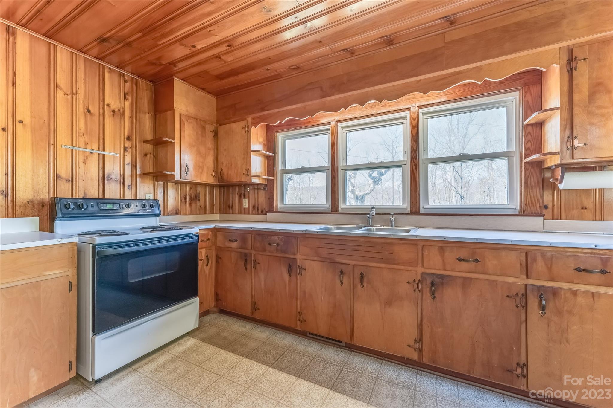 1345 Max Thompson Road Canton, NC 28716 - Photo 10 of 43 a kitchen with stainless steel appliances granite countertop a stove a sink and a microwave