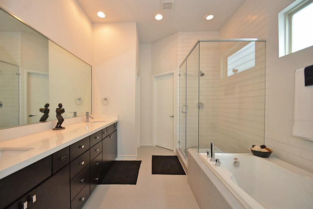 2713 Clay Street Houston, TX 77003 - Photo 5 of 24 Well-lit Master Bathroom features his/her vanities, quartz countertops & large stand up shower/whirlpool tub.