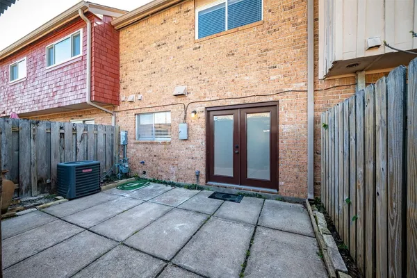 a view of a house with a backyard and wooden fence