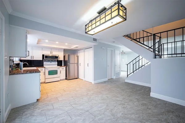 a view of kitchen and hall with wooden floor