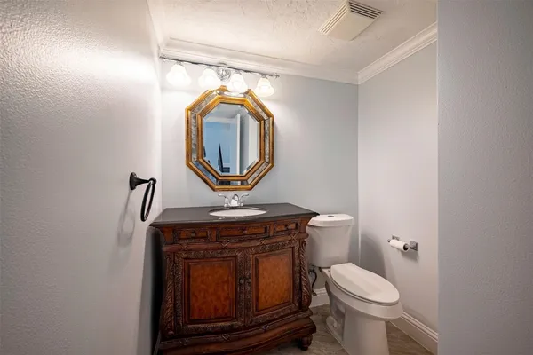 a bathroom with a toilet a sink and a mirror