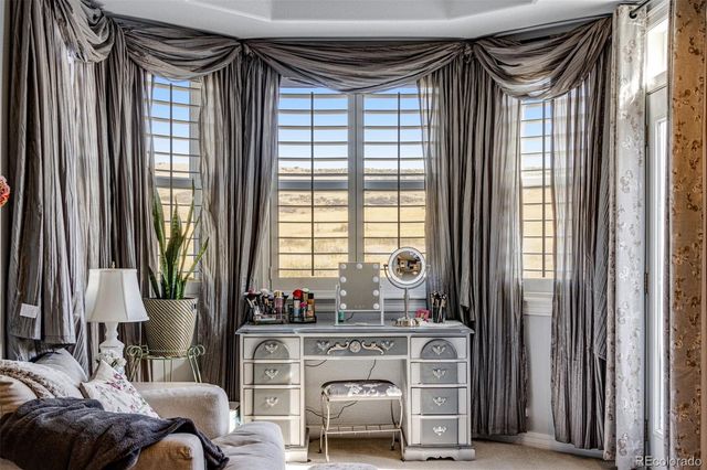 a balcony with wooden floor and outdoor seating