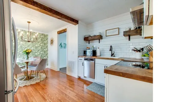 a kitchen with stainless steel appliances granite countertop a refrigerator and a stove top oven