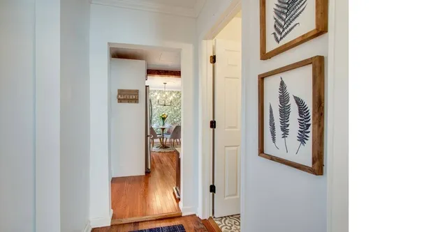 a view of a hallway with wooden floor and entryway