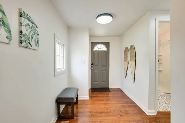 a view of a room with wooden floor and a window