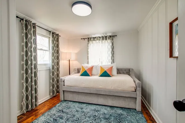 a bedroom with a bed and a window