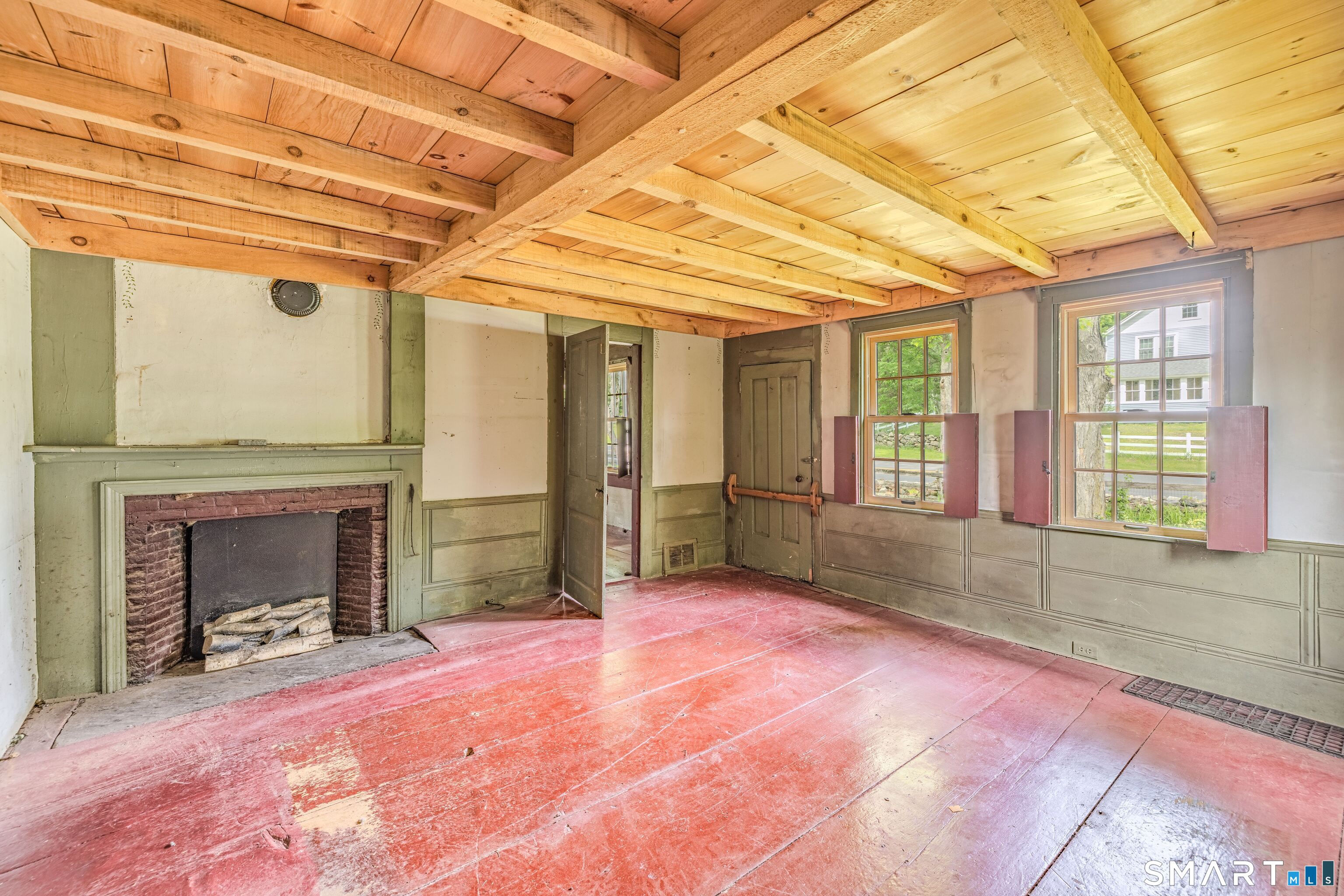 261 Hebron Road Bolton, CT 06043 - Photo 20 of 40 a view of an empty room with a fireplace and a window