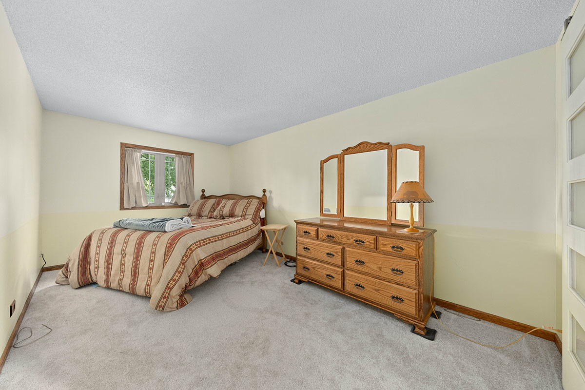 3342 Fox Hill Road Aurora, IL 60504 - Photo 13 of 25 a bedroom with a bed and a dresser