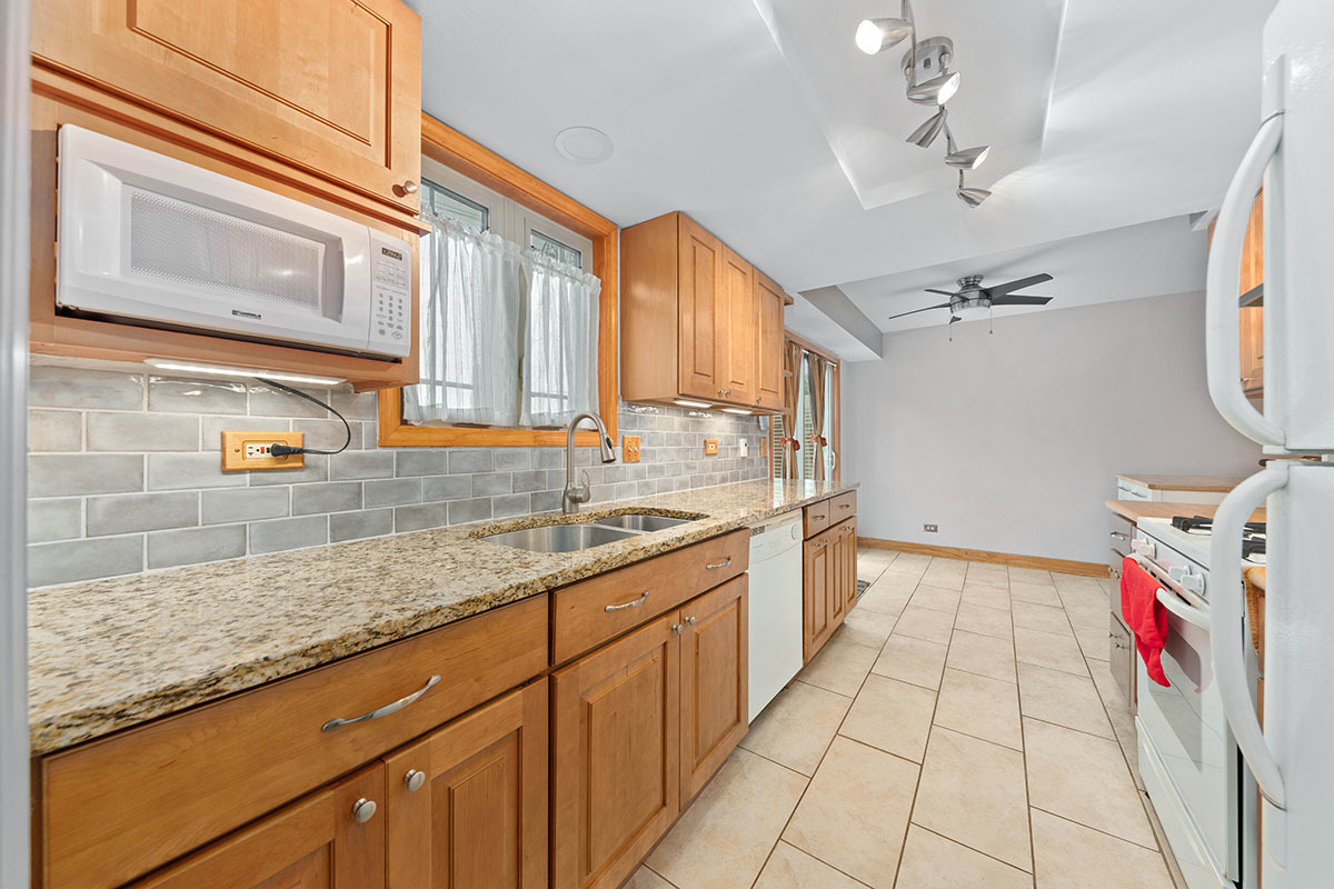 3342 Fox Hill Road Aurora, IL 60504 - Photo 3 of 25 a kitchen with a sink stove and cabinets