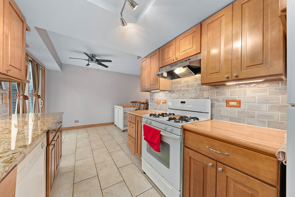 3342 Fox Hill Road Aurora, IL 60504 - Photo 4 of 25 a kitchen with stainless steel appliances granite countertop a stove a sink and a refrigerator