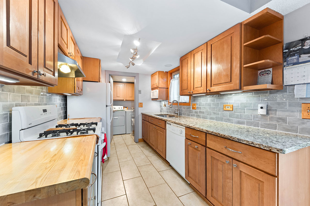 3342 Fox Hill Road Aurora, IL 60504 - Photo 6 of 25 a kitchen with stainless steel appliances granite countertop a stove a sink and a microwave