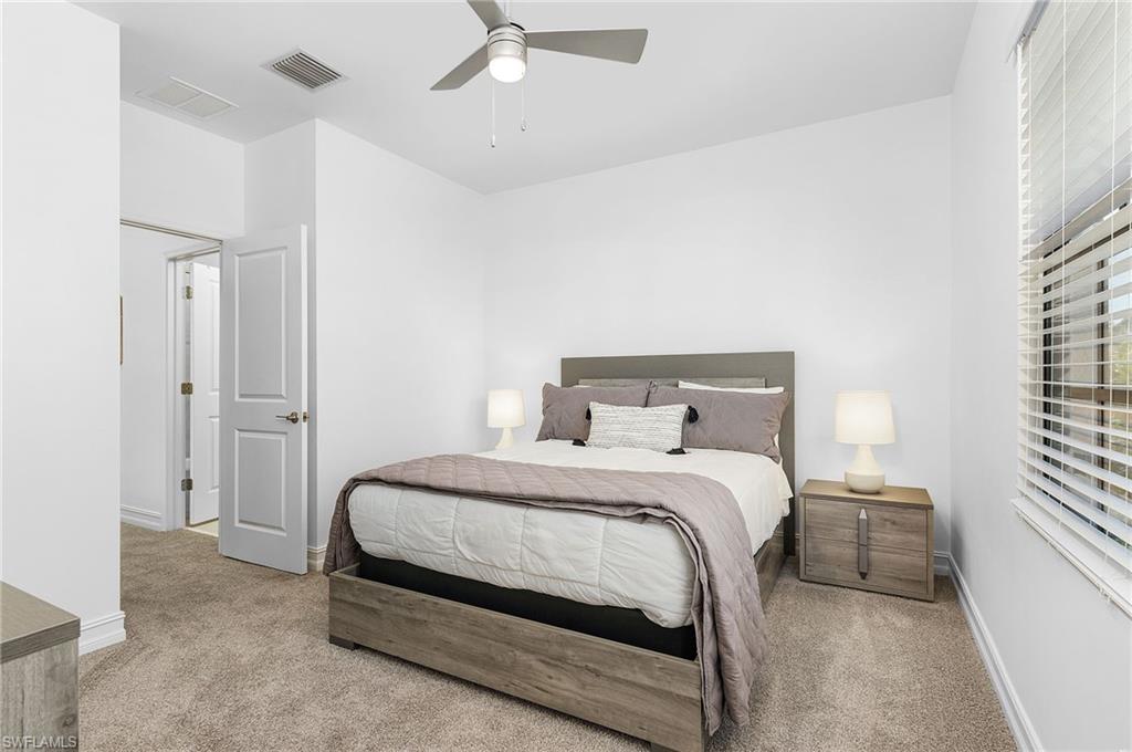 7596 Morgan Way Naples, FL 34119 - Photo 18 of 35 a bedroom with a bed and a window