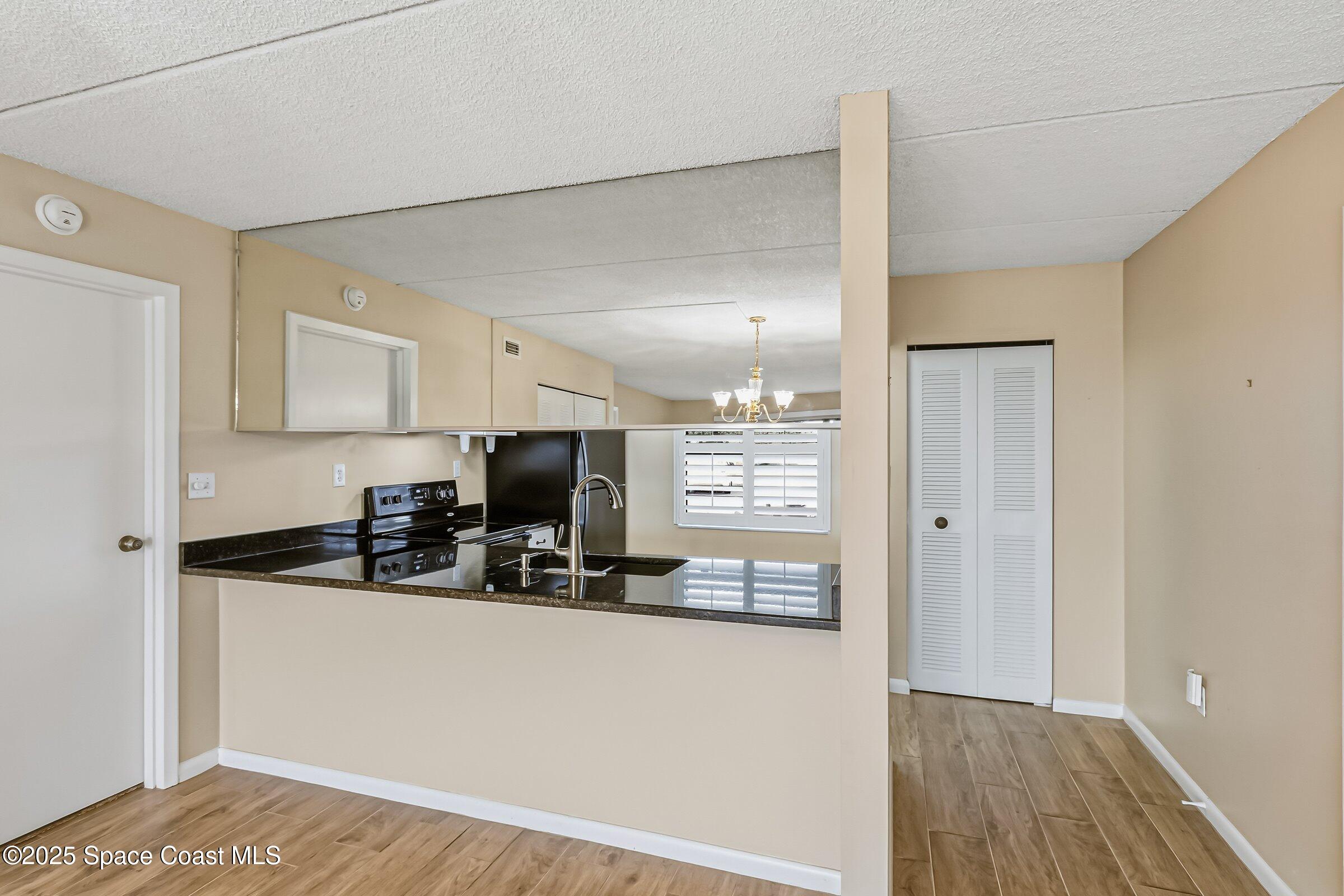 2727 North Wickham Road, Unit 11104 Melbourne, FL 32935 - Photo 15 of 55 a kitchen with stainless steel appliances a refrigerator sink and microwave