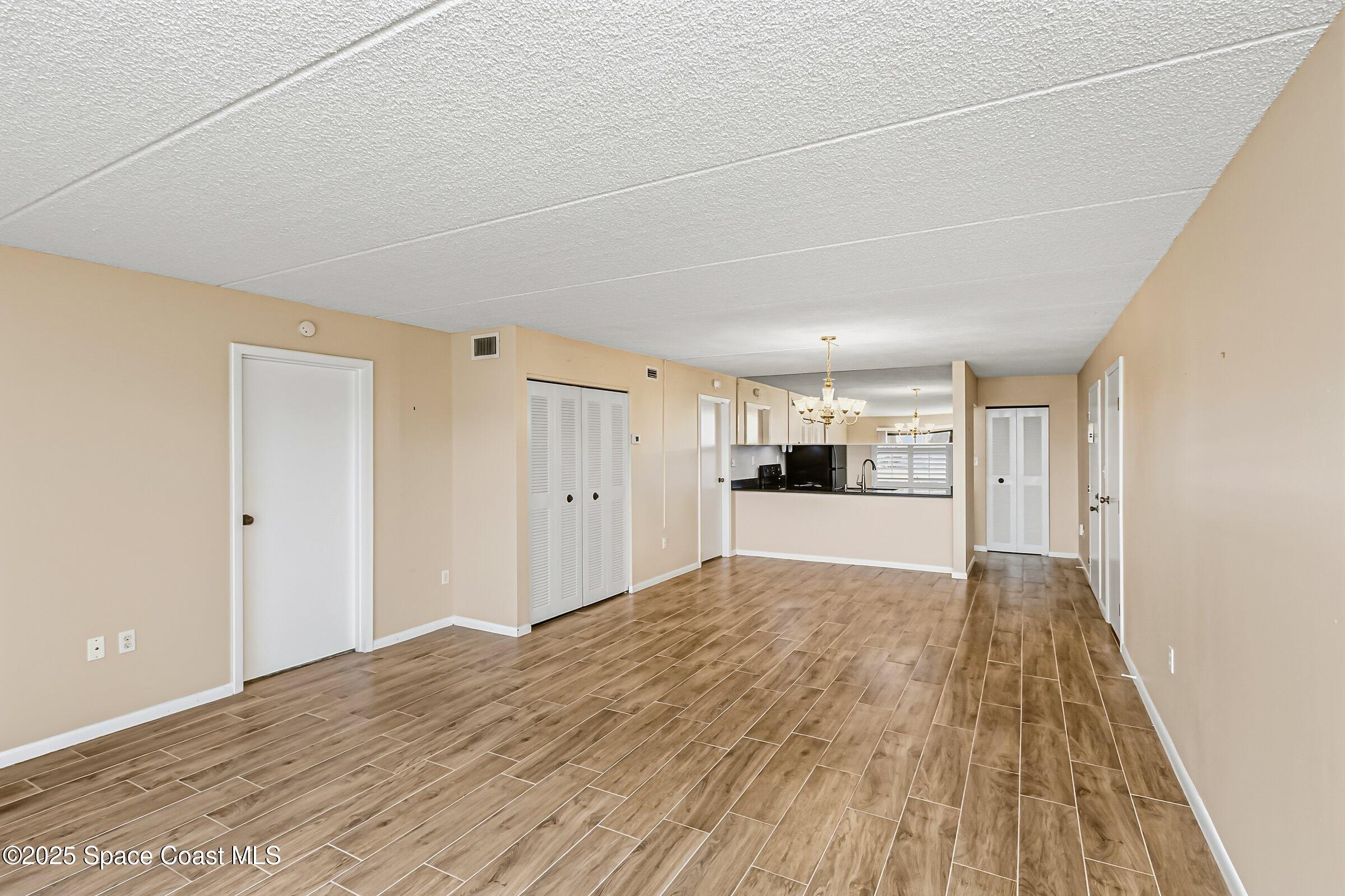 2727 North Wickham Road, Unit 11104 Melbourne, FL 32935 - Photo 16 of 55 a view of a hardwood floor in a room
