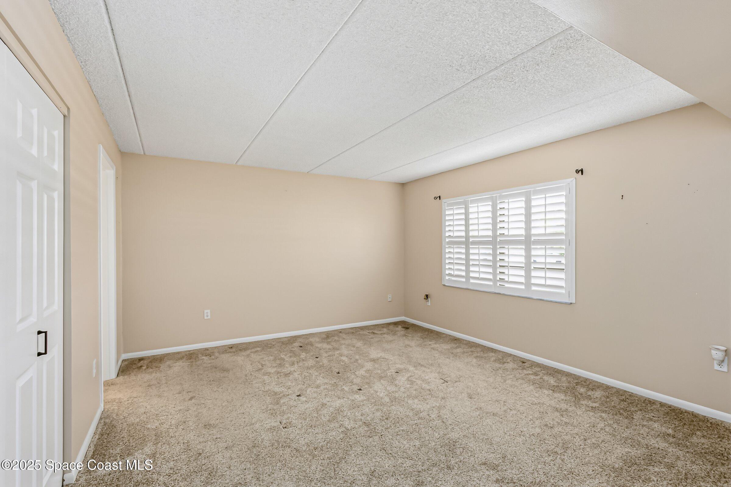 2727 North Wickham Road, Unit 11104 Melbourne, FL 32935 - Photo 20 of 55 an empty room with a window