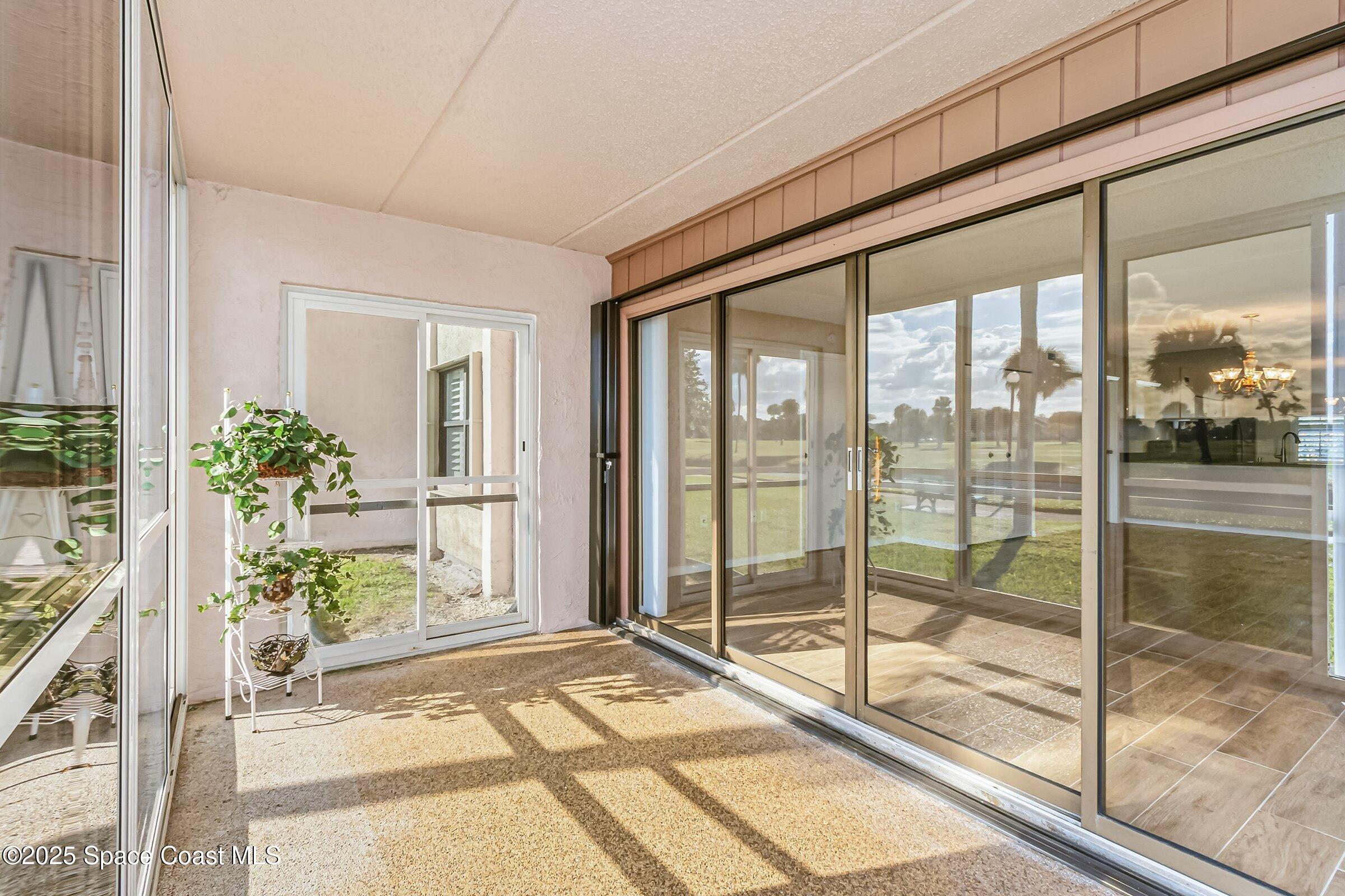 2727 North Wickham Road, Unit 11104 Melbourne, FL 32935 - Photo 26 of 55 a view of a living room and floor to ceiling window