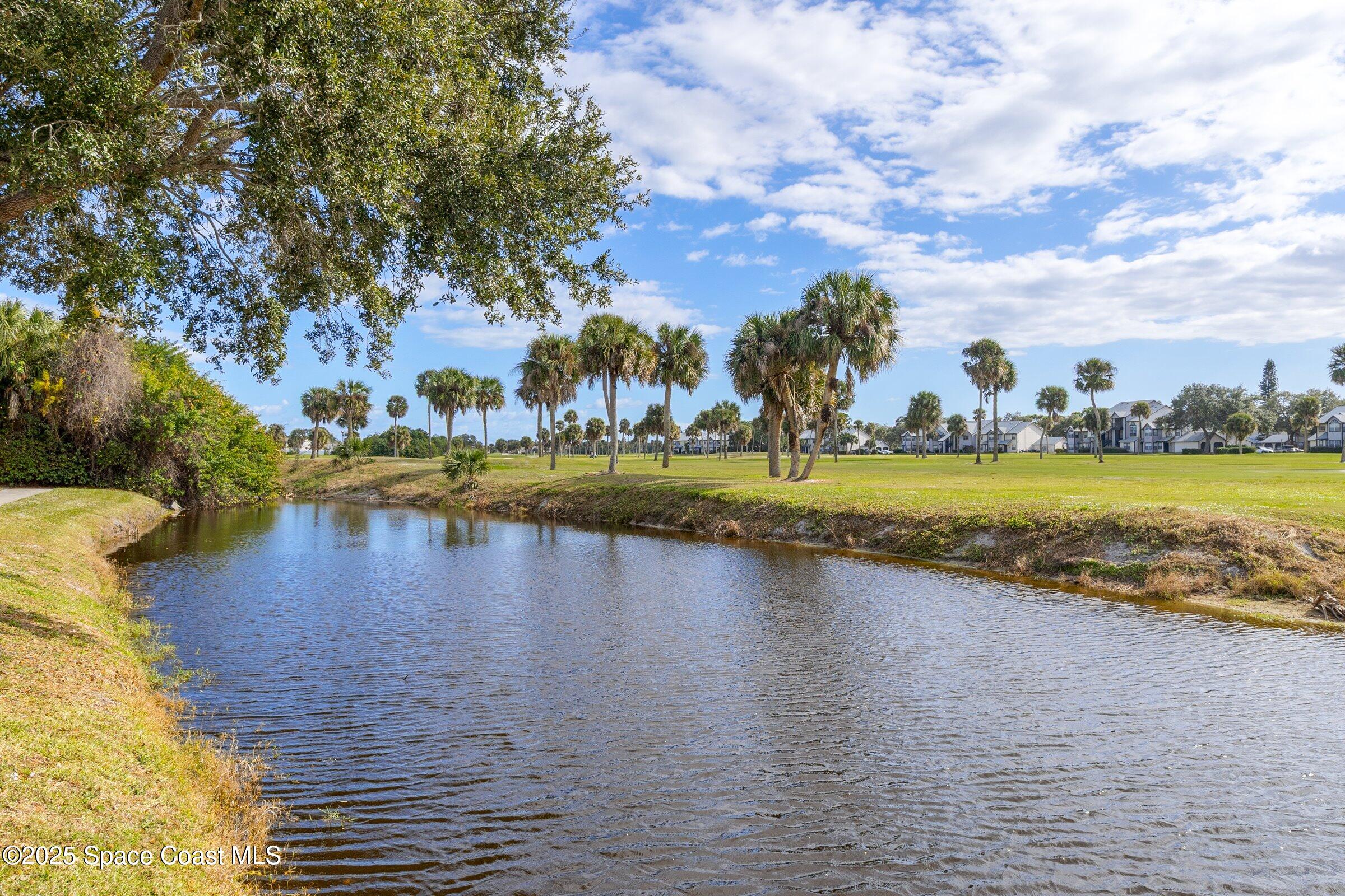 2727 North Wickham Road, Unit 11104 Melbourne, FL 32935 - Photo 39 of 55 a view of a lake with houses in the background