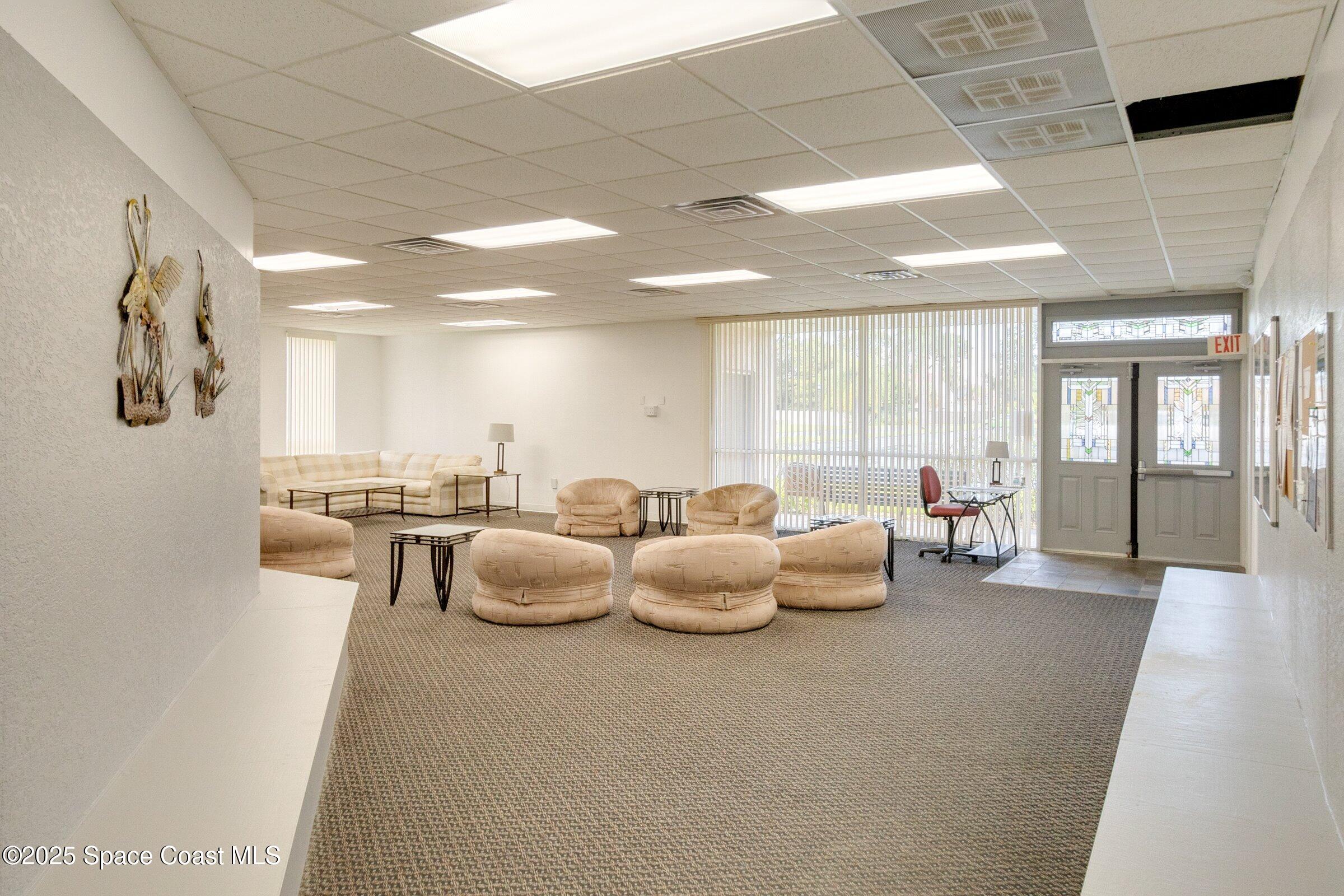 2727 North Wickham Road, Unit 11104 Melbourne, FL 32935 - Photo 40 of 55 a living room with furniture and a large window