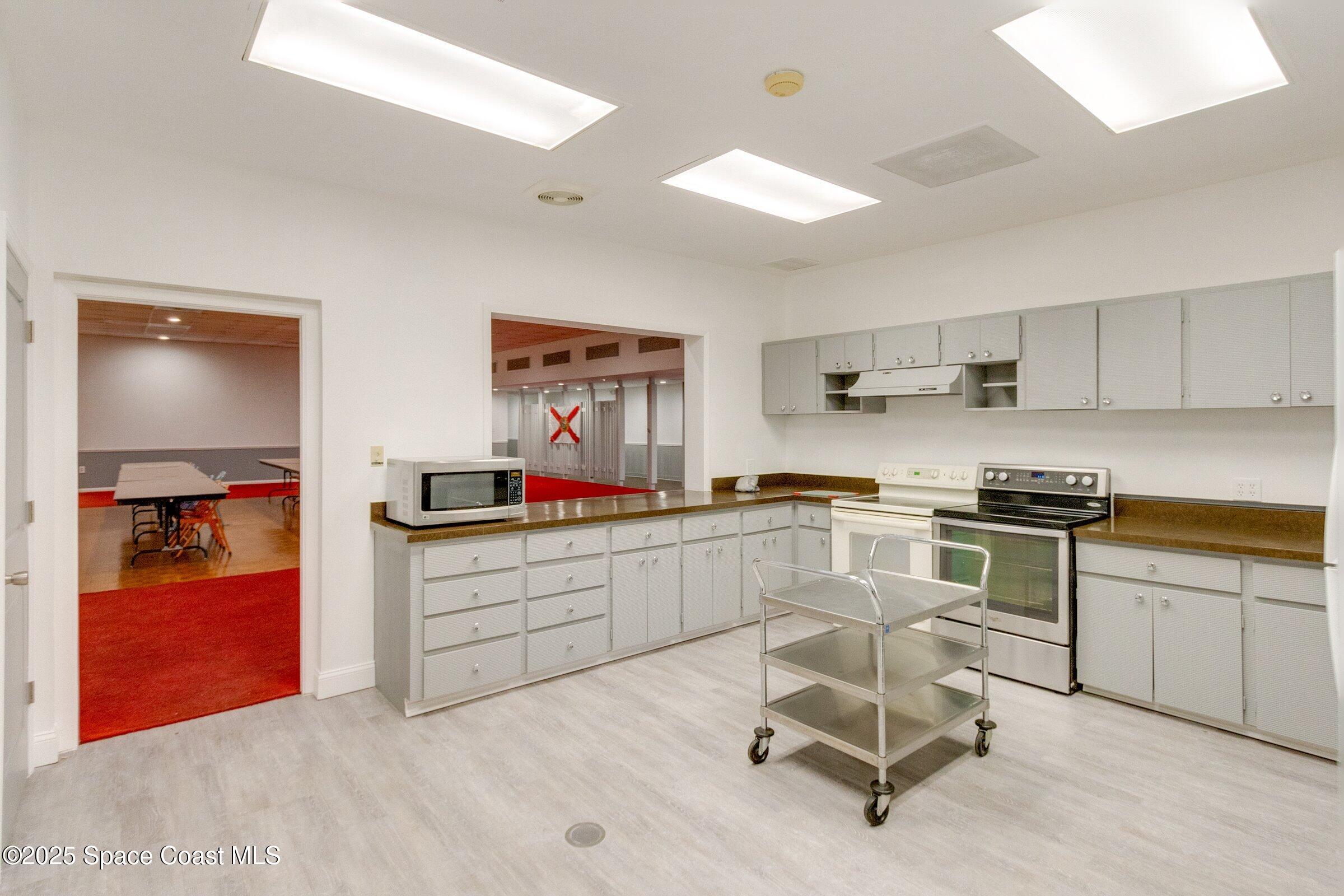 2727 North Wickham Road, Unit 11104 Melbourne, FL 32935 - Photo 45 of 55 a kitchen with a sink cabinets and window