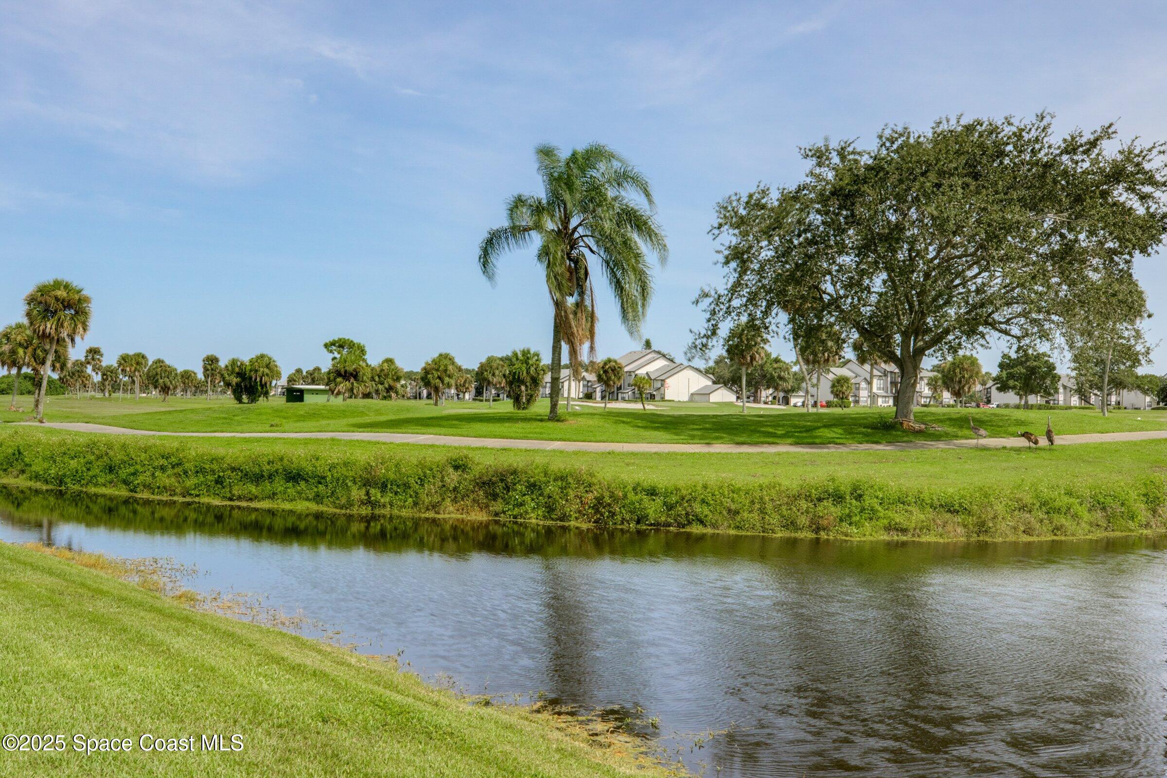 2727 North Wickham Road, Unit 11104 Melbourne, FL 32935 - Photo 48 of 55 a view of a golf course with a lake