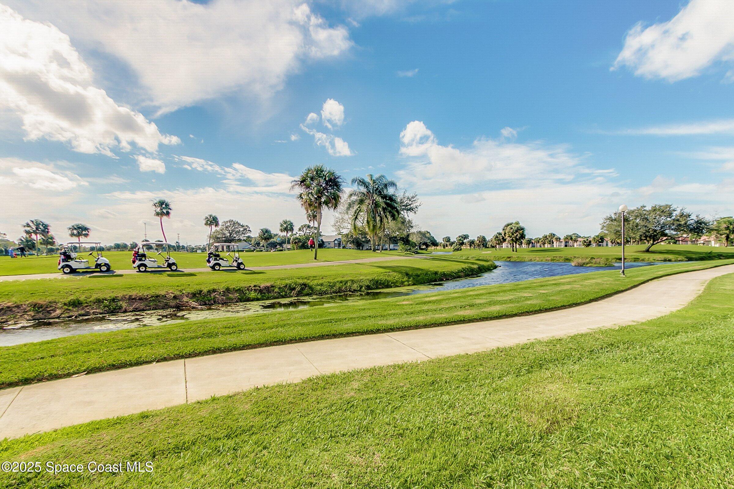 2727 North Wickham Road, Unit 11104 Melbourne, FL 32935 - Photo 49 of 55 a view of a golf course with a lake