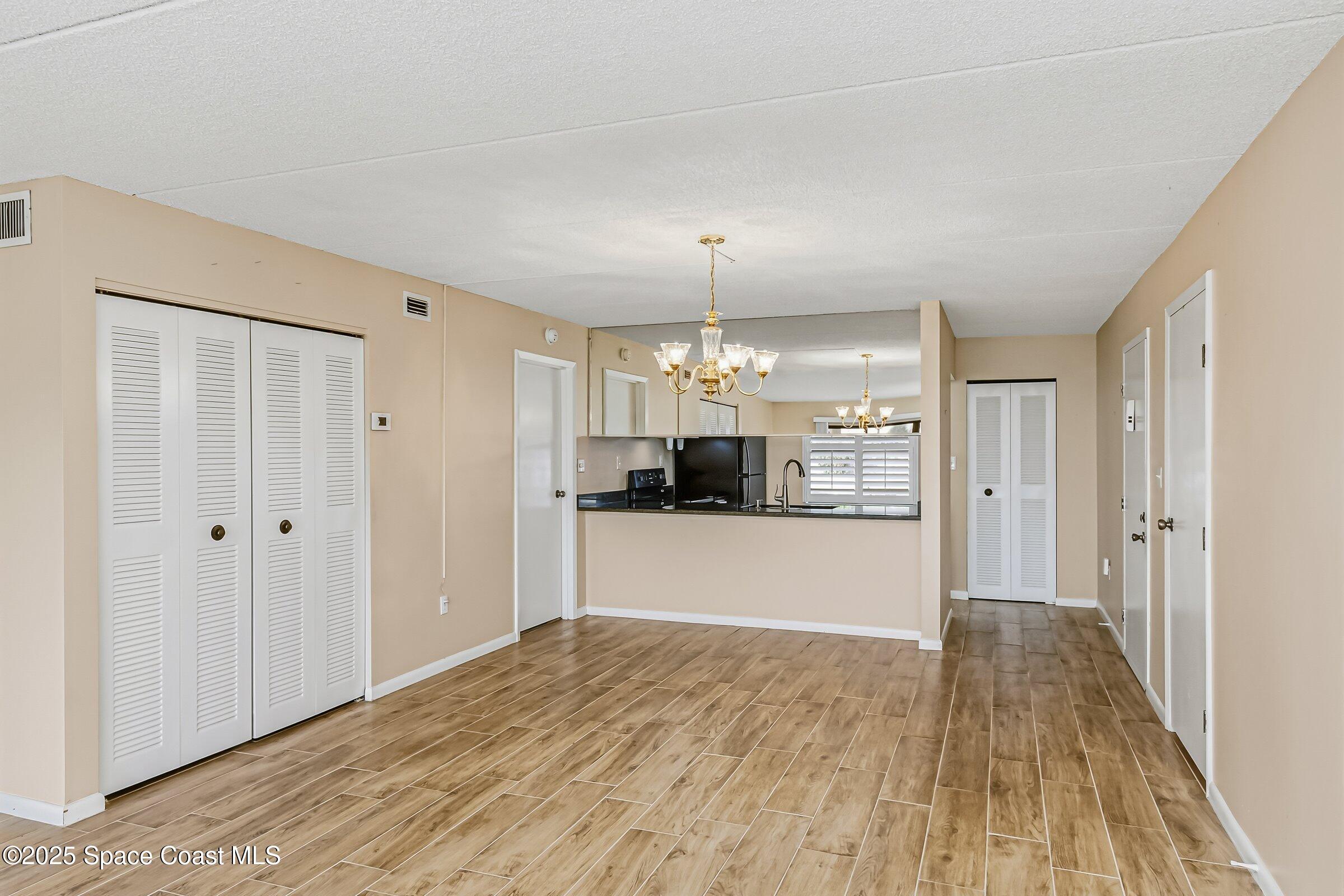 2727 North Wickham Road, Unit 11104 Melbourne, FL 32935 - Photo 7 of 55 a view of a kitchen from the hallway