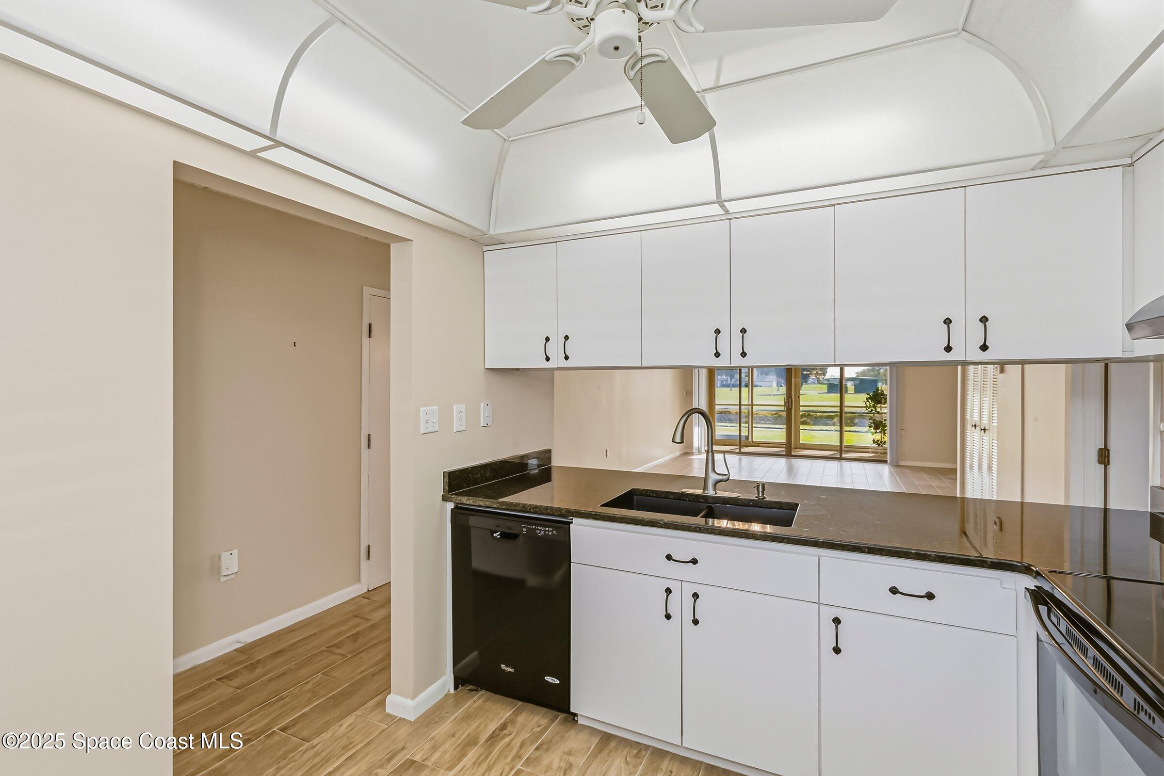 2727 North Wickham Road, Unit 11104 Melbourne, FL 32935 - Photo 10 of 55 a kitchen with stainless steel appliances granite countertop a sink and cabinets