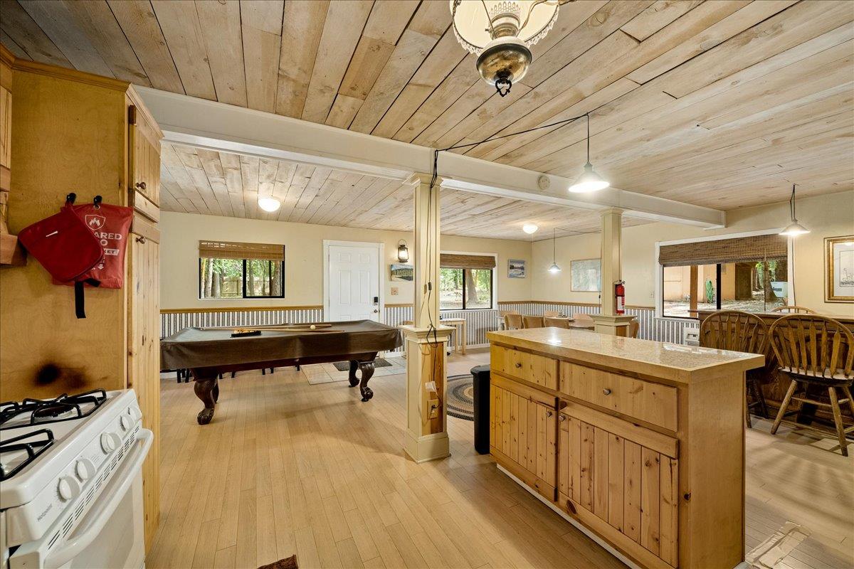 3000 Succor Lane Colfax, CA 95713 - Photo 17 of 56 a large room with kitchen island a sink a stove and a wooden floors