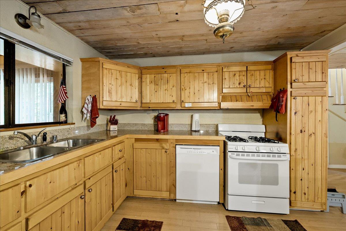 3000 Succor Lane Colfax, CA 95713 - Photo 18 of 56 a kitchen with a stove window and cabinets