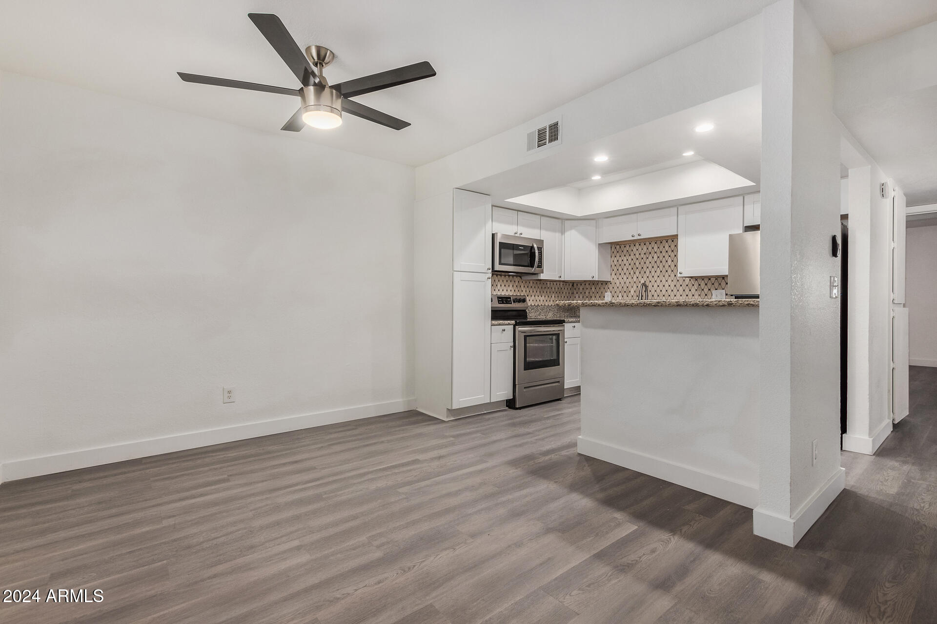 18202 Cave Creek Road, Unit 5S Phoenix, AZ 85032 - Photo 7 of 23 a view of kitchen with stainless steel appliances refrigerator stove microwave and cabinets