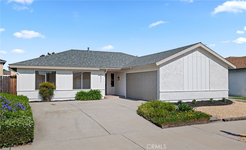 1077 Offshore Street Oxnard, CA 93035 - Photo 1 of 33 a front view of a house with a yard and garage
