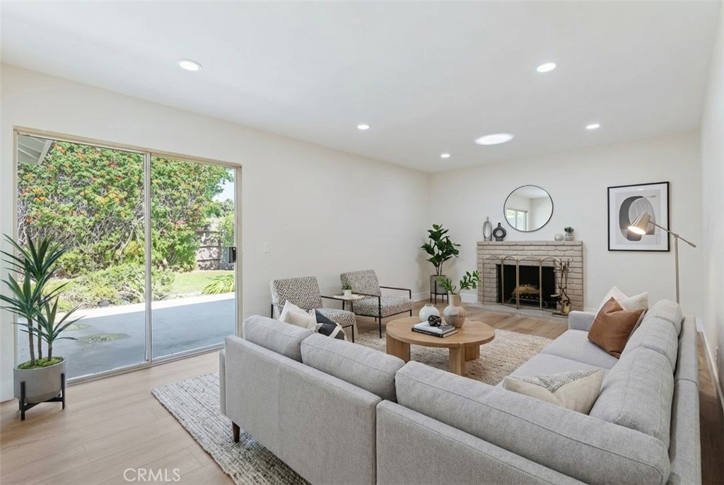 1077 Offshore Street Oxnard, CA 93035 - Photo 11 of 33 a living room with furniture a fireplace and a large window