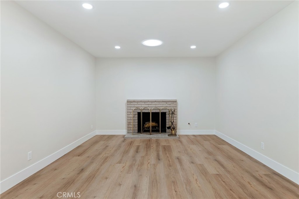 1077 Offshore Street Oxnard, CA 93035 - Photo 12 of 33 a view of empty room with wooden floor and fireplace