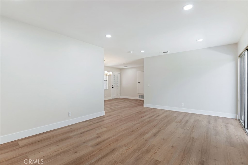 1077 Offshore Street Oxnard, CA 93035 - Photo 15 of 33 a view of an empty room with wooden floor
