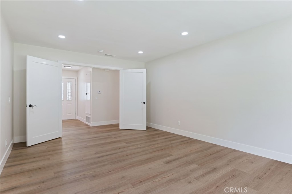 1077 Offshore Street Oxnard, CA 93035 - Photo 17 of 33 a view of an empty room with wooden floor