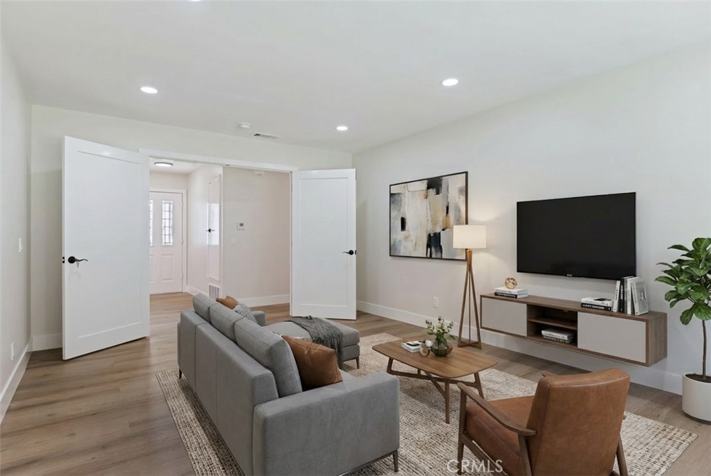 1077 Offshore Street Oxnard, CA 93035 - Photo 18 of 33 a living room with furniture and a flat screen tv